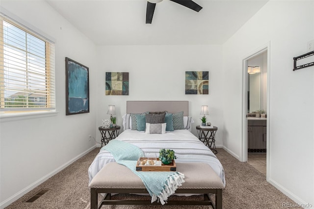 carpeted bedroom featuring ensuite bathroom and ceiling fan