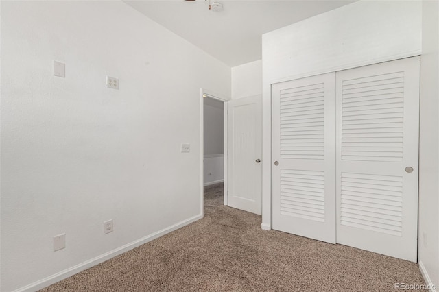 unfurnished bedroom featuring carpet and a closet