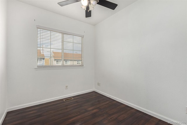 spare room featuring dark hardwood / wood-style flooring and ceiling fan