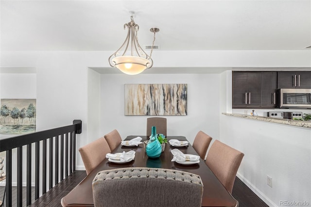 dining space with dark hardwood / wood-style floors