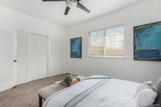 carpeted bedroom with ceiling fan and a closet