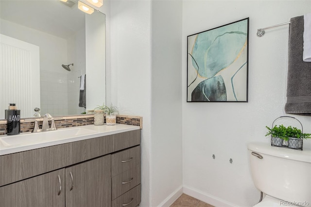 bathroom featuring vanity, toilet, and walk in shower