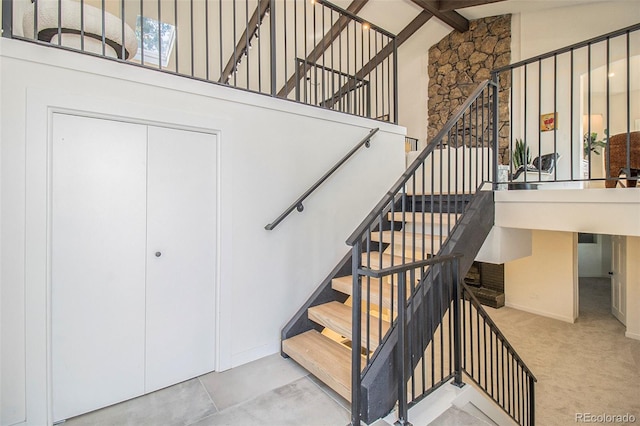 14890 W 58th Pl, Golden, CO 80403 - stairs featuring high vaulted ceiling, beam ceiling, and carpet