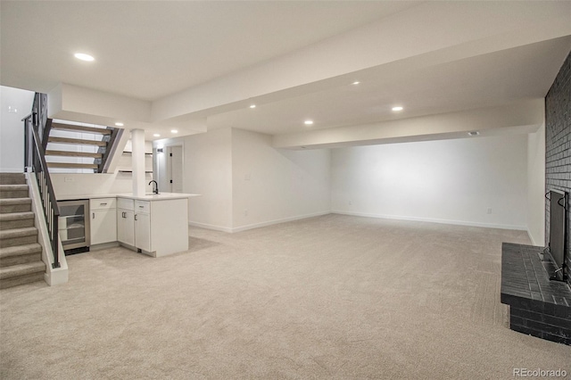 14890 W 58th Pl, Golden, CO 80403 - unfurnished living room with beverage cooler, stairs, light carpet, recessed lighting, and wet bar