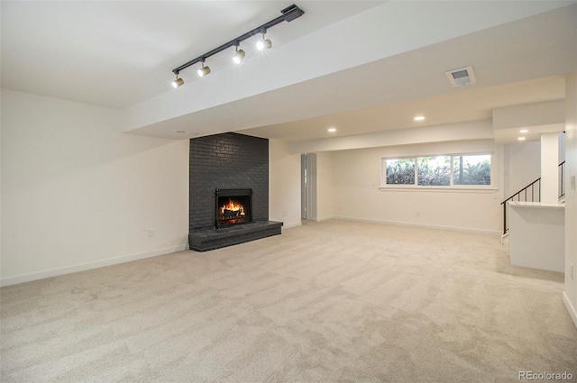 14890 W 58th Pl, Golden, CO 80403 - unfurnished living room featuring light carpet, a fireplace, stairway, recessed lighting, and track lighting