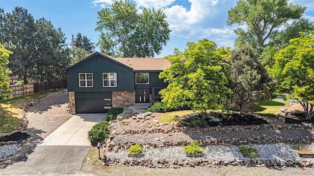 14890 W 58th Pl, Golden, CO 80403 - view of front of home with stone siding, driveway, and an attached garage