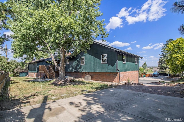 14890 W 58th Pl, Golden, CO 80403 - view of front facade with stairs, brick siding, and a patio area