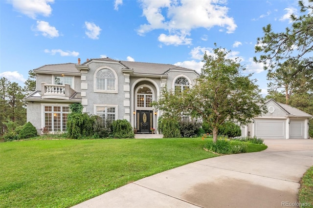 view of front of property featuring a garage and a front yard