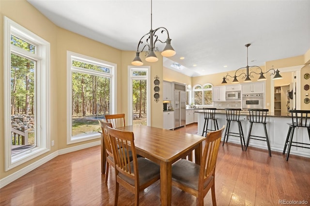 dining space with hardwood / wood-style floors