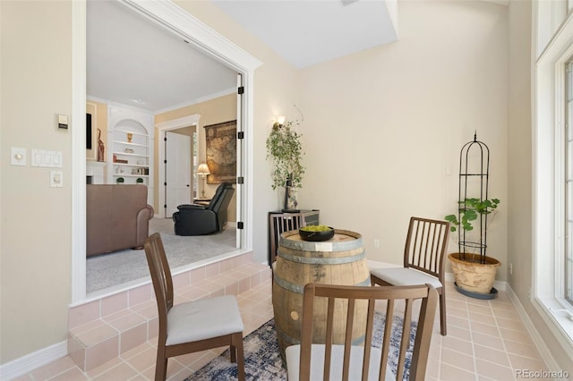 dining space featuring light tile patterned flooring and built in features