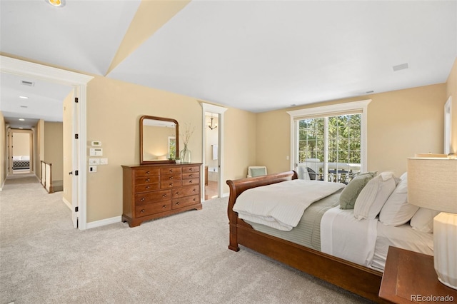 carpeted bedroom featuring ensuite bath and access to outside