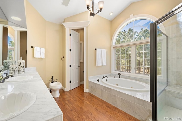 bathroom featuring a bidet, vanity, wood-type flooring, vaulted ceiling, and a chandelier