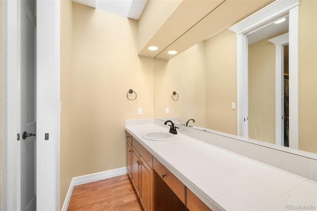 bathroom with vanity and hardwood / wood-style flooring