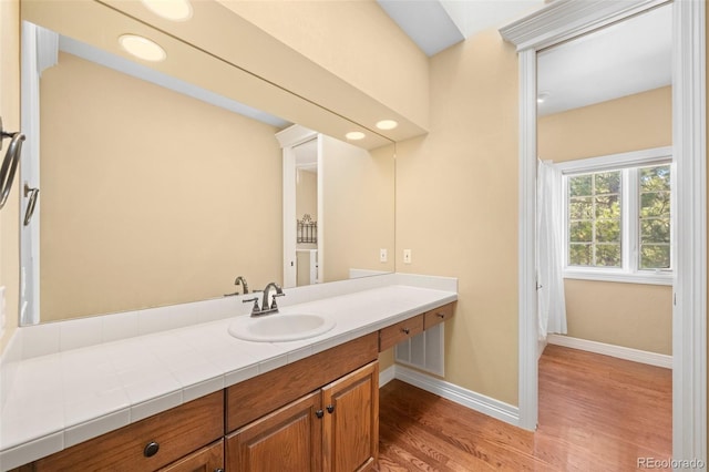 bathroom with vanity and wood-type flooring