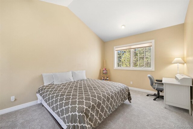 bedroom featuring lofted ceiling and carpet flooring