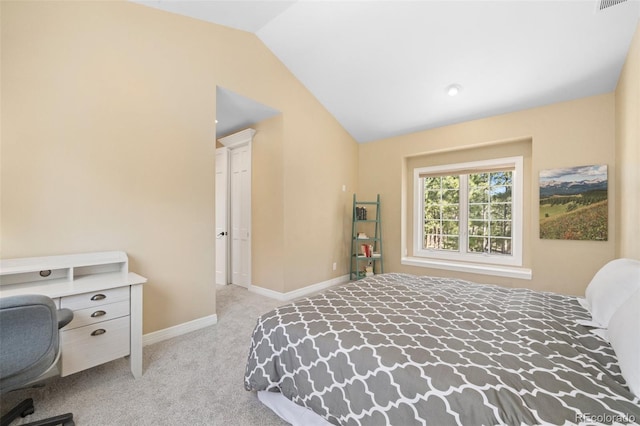 carpeted bedroom with lofted ceiling