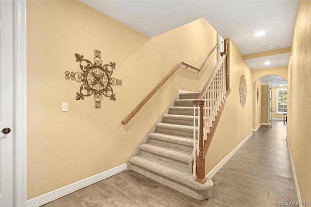 staircase featuring wood-type flooring