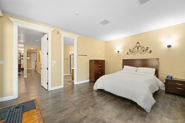 bedroom with dark hardwood / wood-style floors