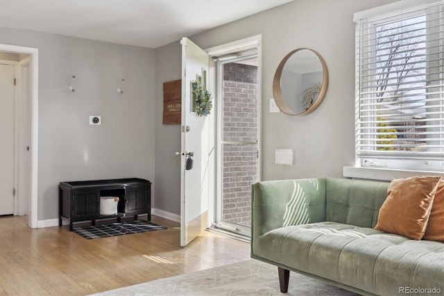 living area with wood finished floors and baseboards