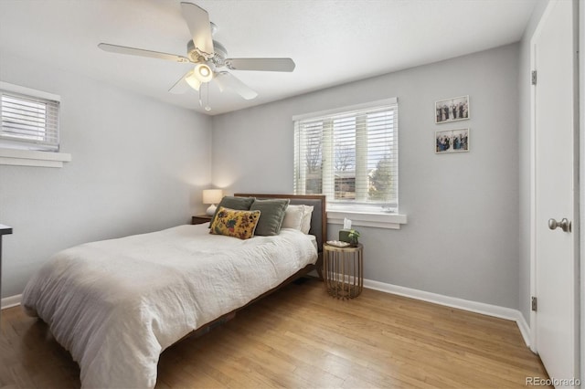 bedroom with wood finished floors, baseboards, and ceiling fan