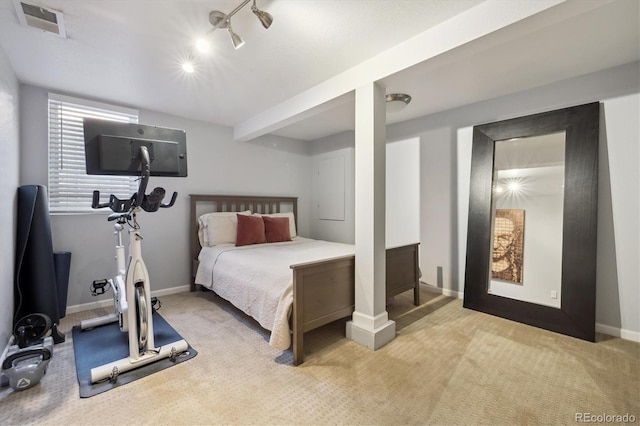 carpeted bedroom featuring track lighting, baseboards, and visible vents