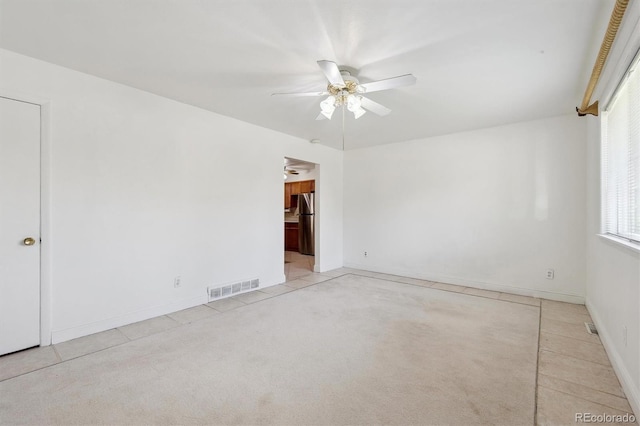 unfurnished room with ceiling fan, carpet flooring, and baseboards