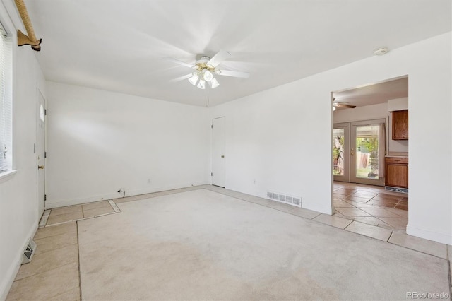 unfurnished room featuring a ceiling fan, light tile patterned floors, french doors, and baseboards