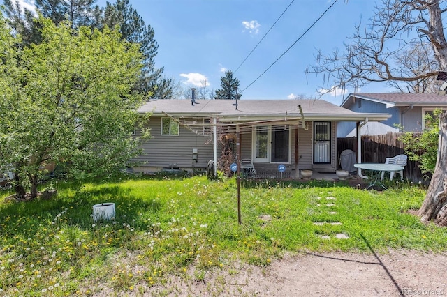back of house featuring fence