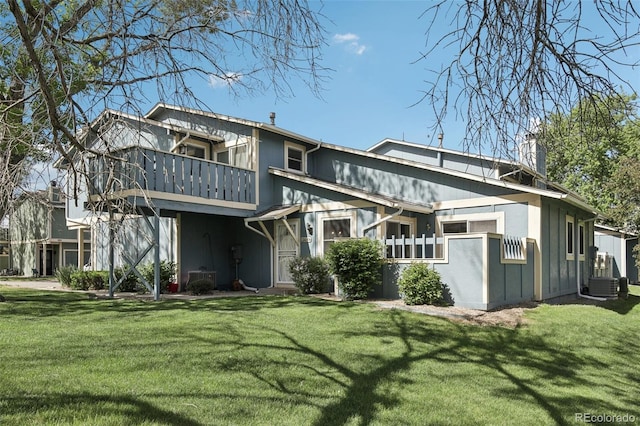 12115 Bannock St Unit B, Denver, CO 80234 - back of property featuring a chimney, a lawn, and a balcony