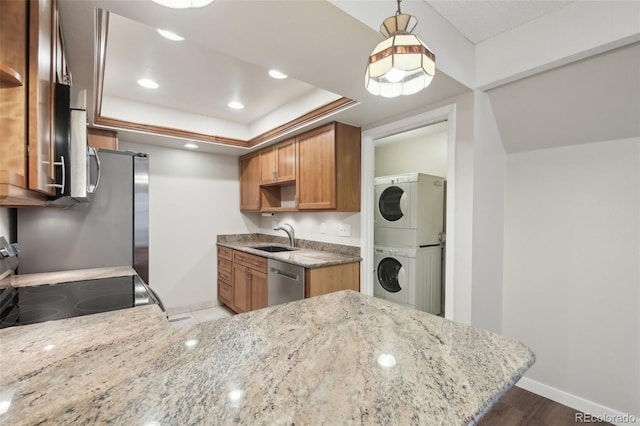 12115 Bannock St Unit B, Denver, CO 80234 - kitchen with stacked washing machine and dryer, a sink, dishwasher, electric range, and light stone counters