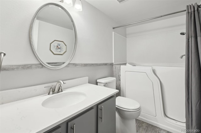 12115 Bannock St Unit B, Denver, CO 80234 - full bathroom with vanity, wood finished floors, toilet, and a shower