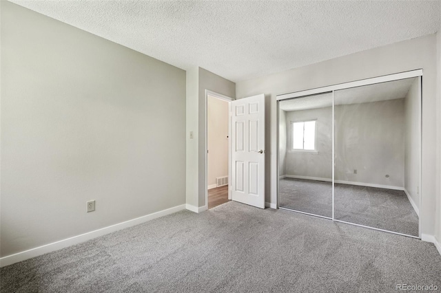 12115 Bannock St Unit B, Denver, CO 80234 - unfurnished bedroom featuring carpet flooring, a closet, a textured ceiling, and baseboards