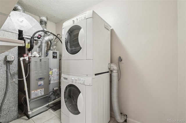 12115 Bannock St Unit B, Denver, CO 80234 - laundry area featuring estacked washer and dryer, water heater, light tile patterned floors, and a textured ceiling