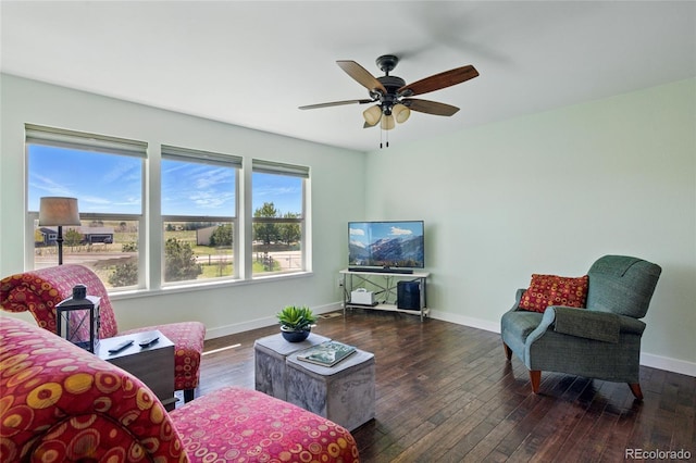 living room with baseboards, ceiling fan, and hardwood / wood-style floors