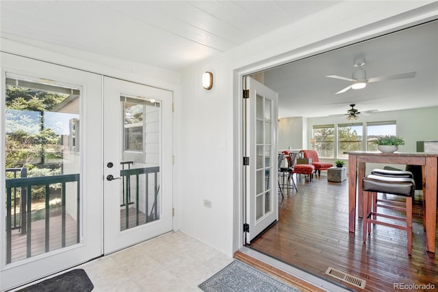 entryway with ceiling fan, visible vents, and french doors