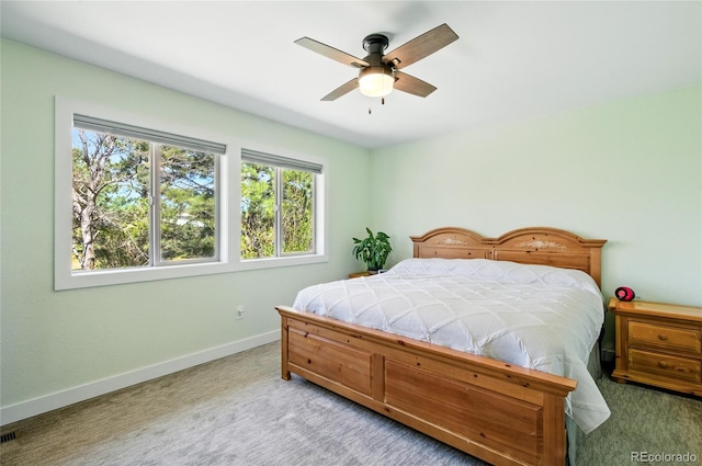 bedroom featuring baseboards, multiple windows, a ceiling fan, and carpet flooring