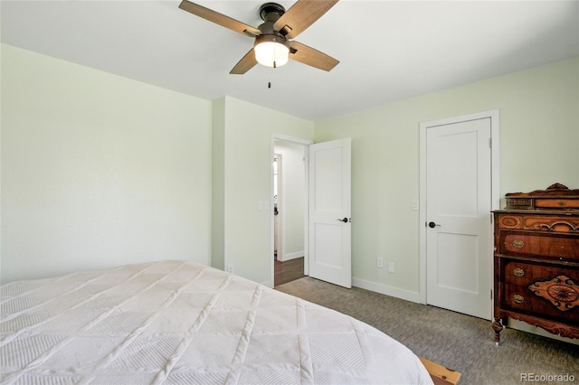 carpeted bedroom featuring baseboards and a ceiling fan