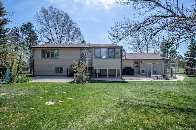 rear view of house featuring a patio, fence, a yard, and a chimney