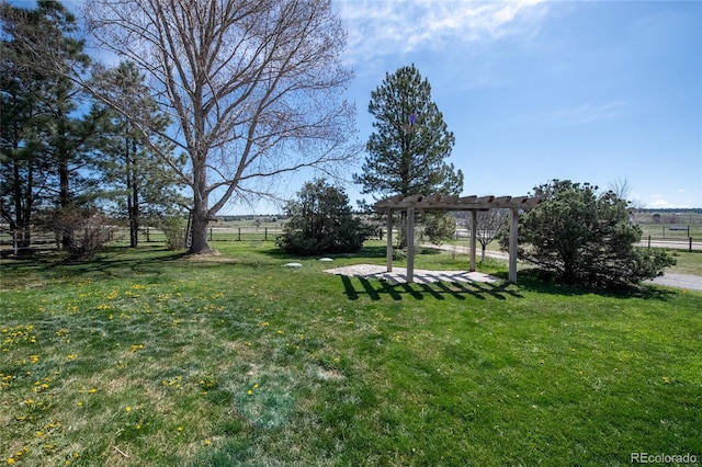 view of yard featuring fence and a pergola
