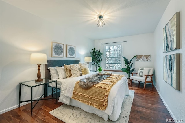 bedroom with dark wood-style floors and baseboards