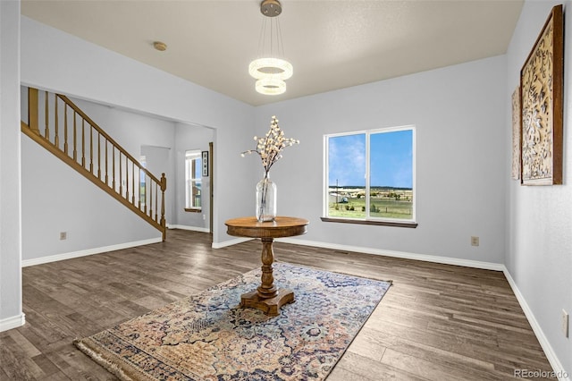 12255 Forest Green Dr, Elbert, CO 80106 - unfurnished dining area with stairs, healthy amount of natural light, wood finished floors, and baseboards