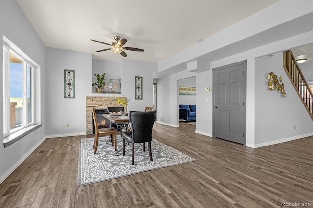 12255 Forest Green Dr, Elbert, CO 80106 - dining area with wood finished floors, a ceiling fan, stairs, and baseboards