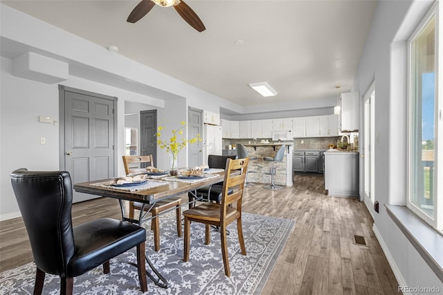 12255 Forest Green Dr, Elbert, CO 80106 - dining room featuring wood finished floors, a ceiling fan, and baseboards