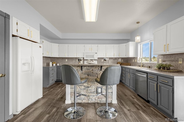 12255 Forest Green Dr, Elbert, CO 80106 - kitchen with white appliances, gray cabinetry, a sink, white cabinets, and dark wood-type flooring
