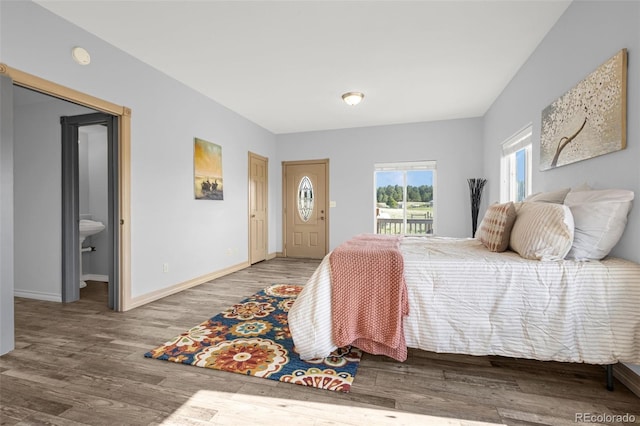 12255 Forest Green Dr, Elbert, CO 80106 - bedroom featuring access to exterior, wood finished floors, and baseboards