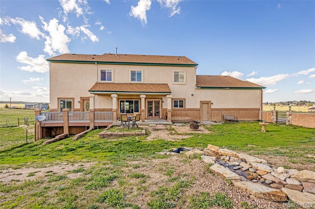 12255 Forest Green Dr, Elbert, CO 80106 - back of property with stucco siding, an outdoor fire pit, and a patio area