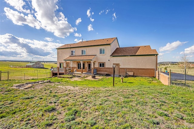 12255 Forest Green Dr, Elbert, CO 80106 - rear view of house featuring a patio area, stucco siding, and a view of rural / pastoral area