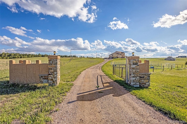 12255 Forest Green Dr, Elbert, CO 80106 - view of dirt / gravel driveway with a view of countryside and a gated entry