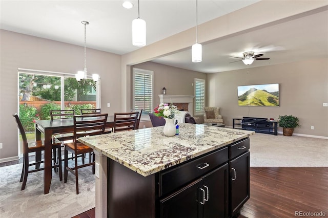 3014 E 143rd Dr, Thornton, CO 80602 - kitchen featuring open floor plan, healthy amount of natural light, a fireplace, and a chandelier