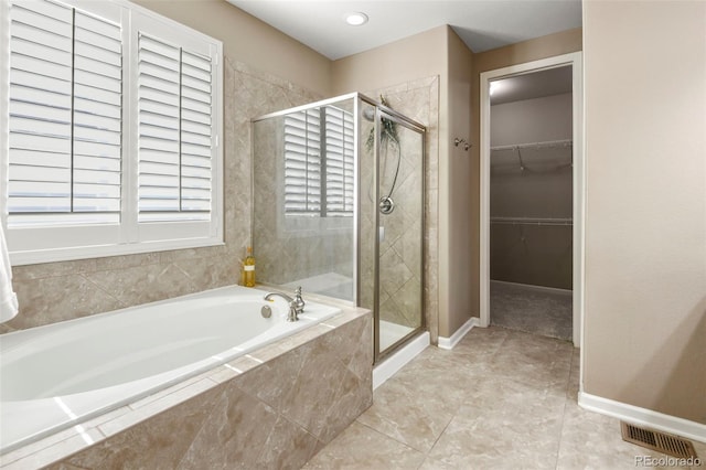 3014 E 143rd Dr, Thornton, CO 80602 - bathroom with a garden tub, a stall shower, and plenty of natural light
